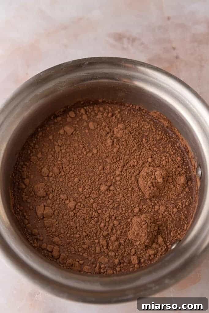 Unmixed ingredients for hot chocolate in a pot, ready for heating.