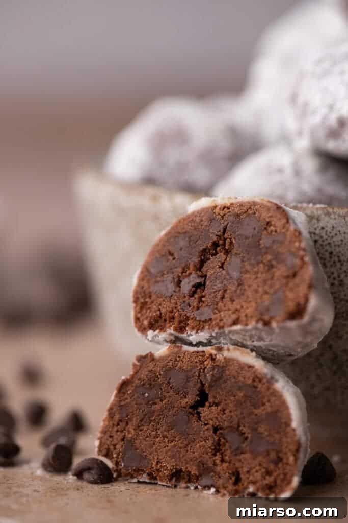 Two chocolate cookies stacked to show their soft interior.