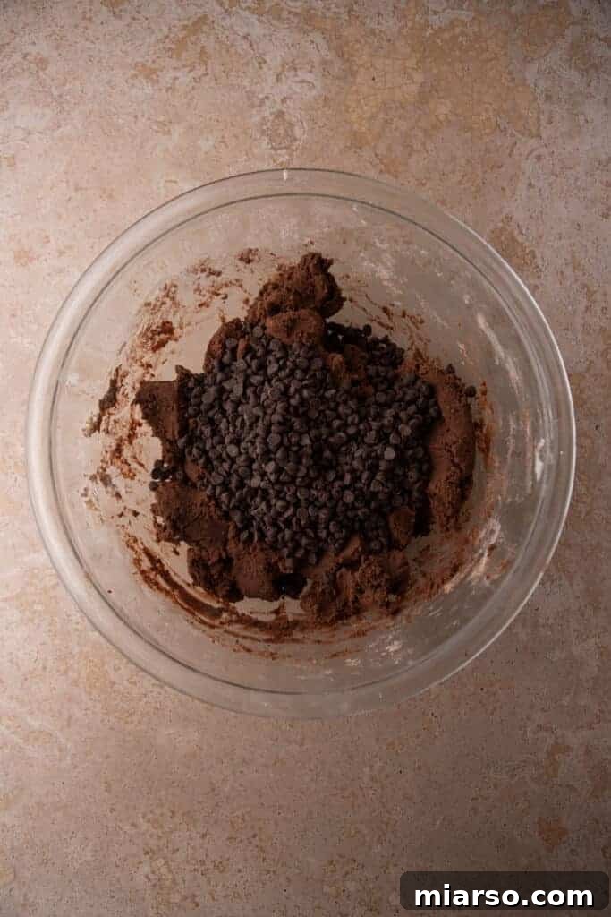 Finished chocolate cookie dough in a glass bowl.
