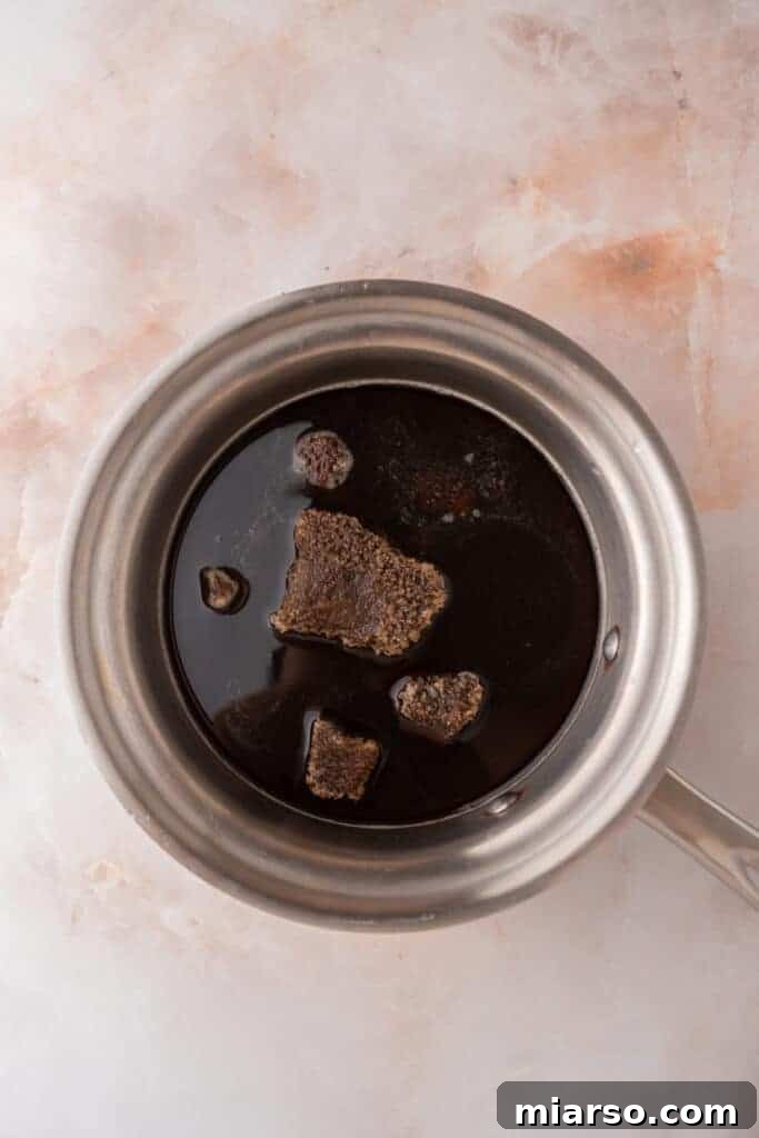Unmixed brown sugar syrup ingredients in a saucepan before heating.