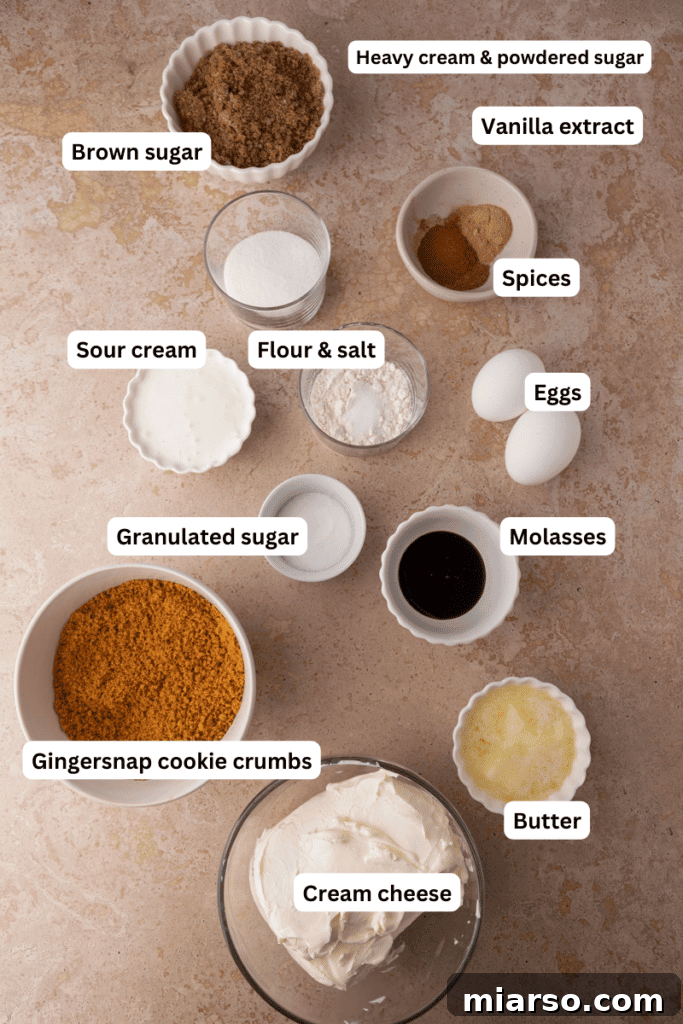 Arrangement of fresh ingredients for gingerbread cheesecake bars, including cream cheese, spices, and gingersnap cookies.