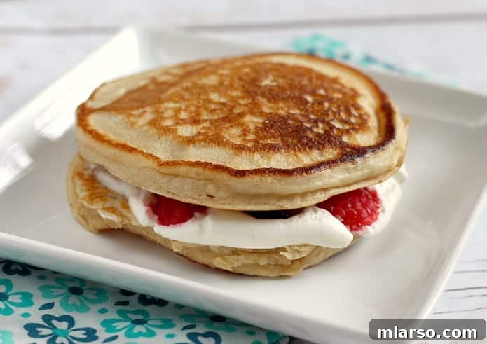 Fruit and cream stuffed pancake sandwiches, an indulgent treat