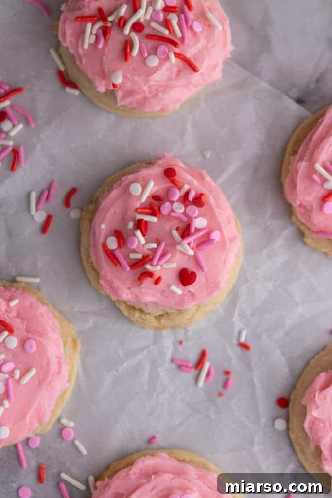 Ultimate Valentine Frosted Sugar Cookies 13 Overhead shot of freshly frosted cookies with pink frosting and colorful sprinkles