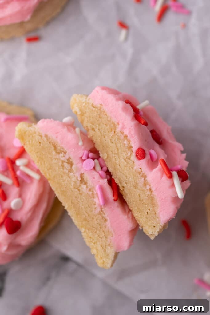 Ultimate Valentine Frosted Sugar Cookies 14 Valentine's Day frosted sugar cookie sliced in half, showing interior