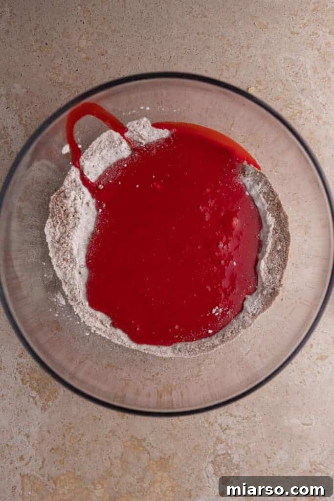 Unmixed dry ingredients in a bowl, showing the flour and cocoa powder.