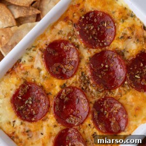 Overhead shot of a diagonal plate of fully cooked cottage cheese pizza bowl dip