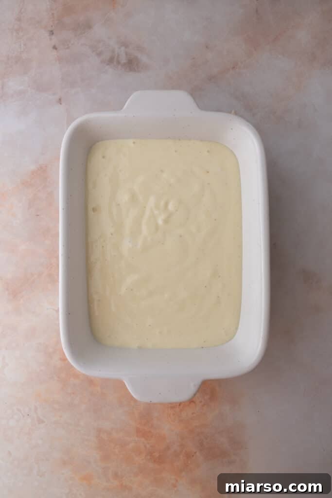 Smooth, blended cottage cheese prepared as the base for the pizza bowl dip, ready for layering.
