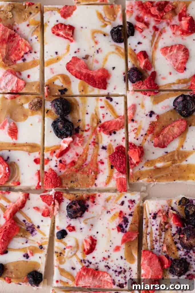 Protein Packed Cottage Cheese Freezer Bark 2 A sheet of freshly made frozen cottage cheese bark, perfectly cut into squares and ready to serve.