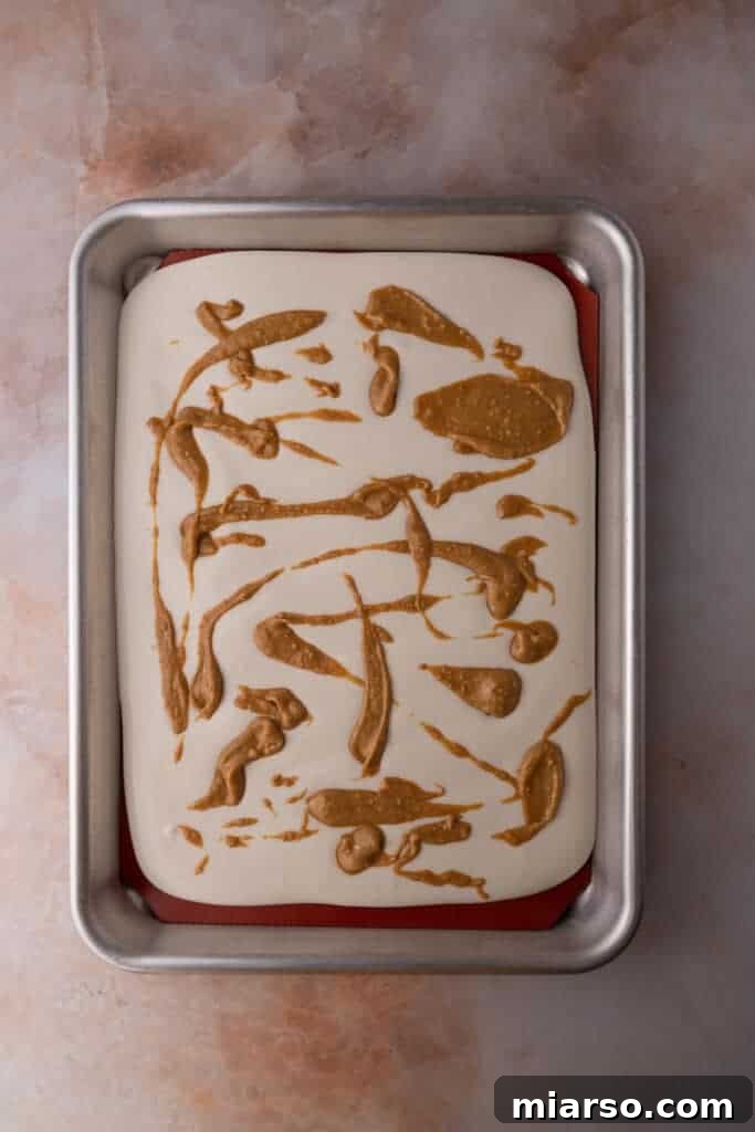 Protein Packed Cottage Cheese Freezer Bark 7 The blended cottage cheese mixture spread evenly on a parchment-lined baking sheet, ready for toppings.