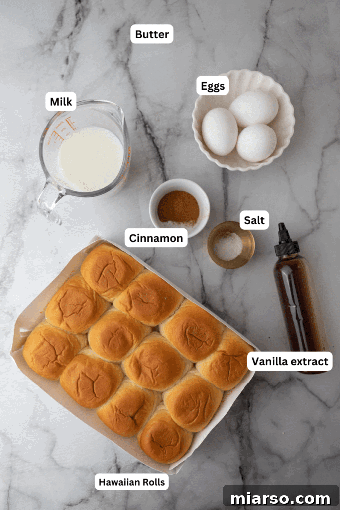 All the fresh ingredients for Hawaiian roll French toast laid out on a clean counter, including rolls, eggs, milk, and spices.
