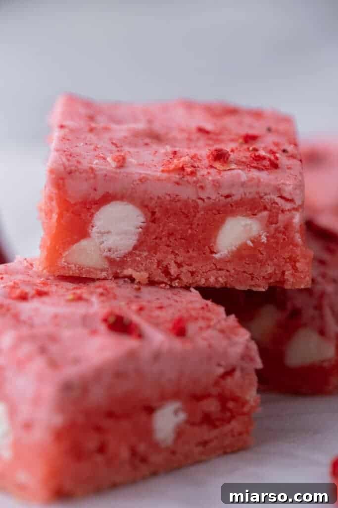 Irresistibly Easy Strawberry Brownies from a Cake Mix 11 Two perfectly glazed strawberry brownies stacked on top of each other, ready to be enjoyed.