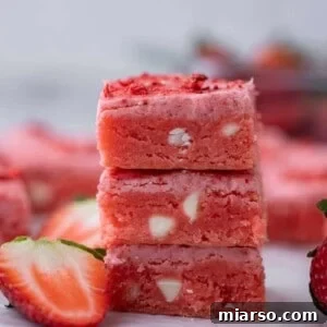 Irresistibly Easy Strawberry Brownies from a Cake Mix 14 Three strawberry brownies stacked on top of each other