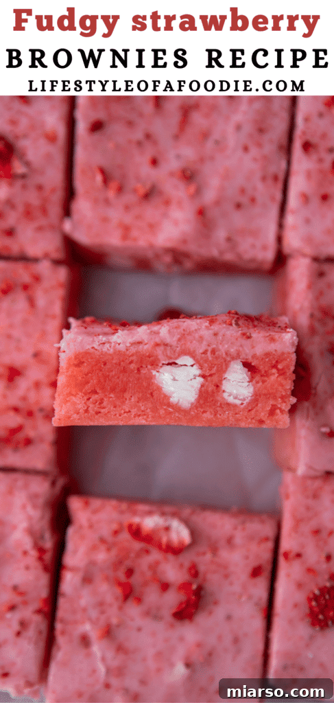 Irresistibly Easy Strawberry Brownies from a Cake Mix 16 Close-up side view of a strawberry brownie, highlighting its fudgy texture and thick glaze.