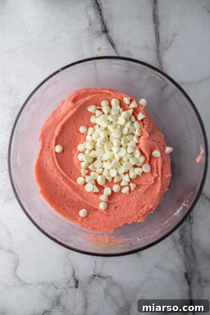 Irresistibly Easy Strawberry Brownies from a Cake Mix 6 Mixed strawberry brownie batter in a bowl, showing its vibrant pink color.