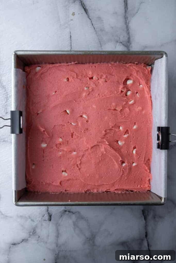 Irresistibly Easy Strawberry Brownies from a Cake Mix 7 Strawberry brownie batter spread evenly in a prepared baking pan.