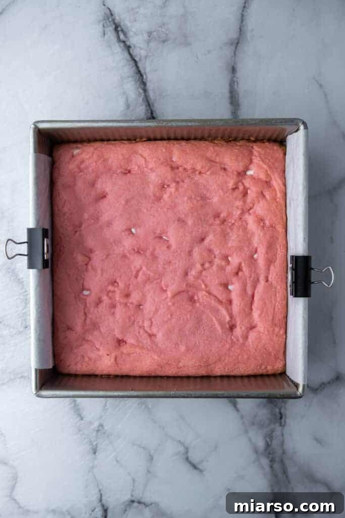Irresistibly Easy Strawberry Brownies from a Cake Mix 8 Freshly baked strawberry brownies cooling in the pan before glazing.