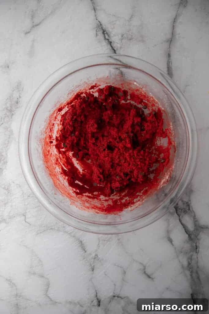 A bowl filled with finished edible red velvet cookie dough, ready to be enjoyed.