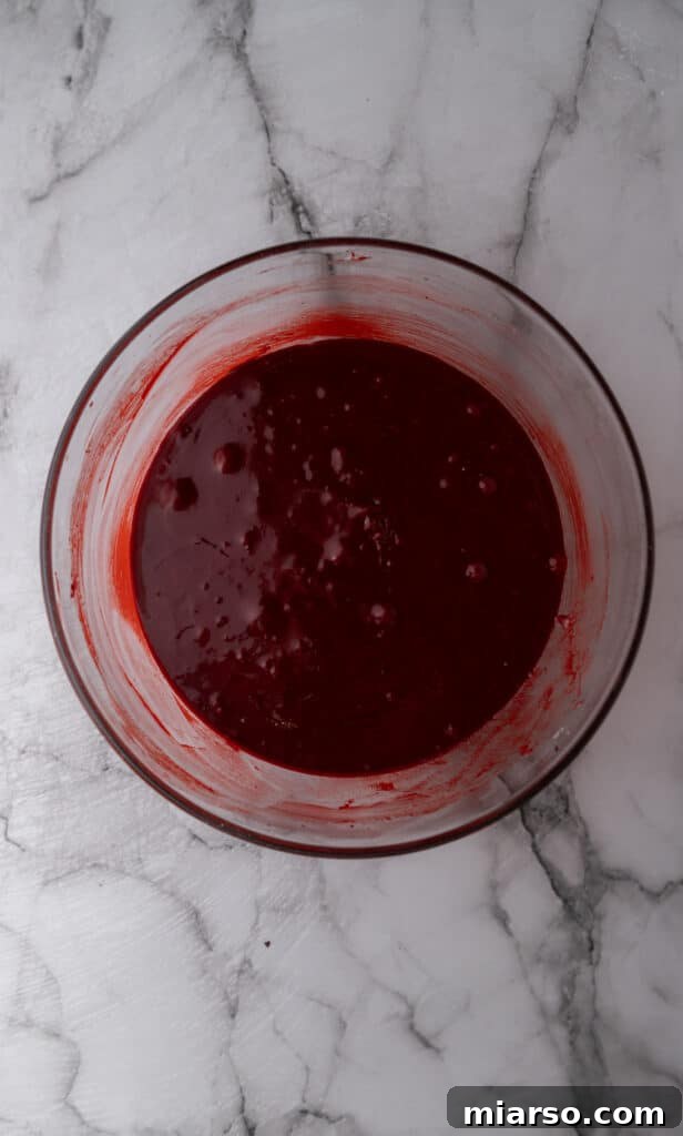 Red velvet brownie batter, fully mixed and vibrant, showcasing its perfect consistency.