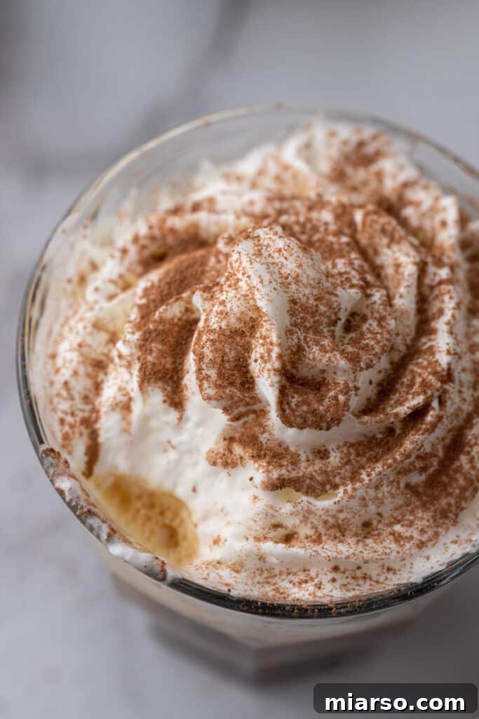 The Ultimate Einspanner Coffee with Velvety Whipped Cream 4 close overhead shot of einspanner coffee recipe with creamy swirls