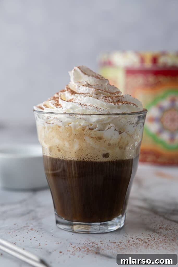 The Ultimate Einspanner Coffee with Velvety Whipped Cream 7 espresso and whipped cream with cocoa powder in a glass cup