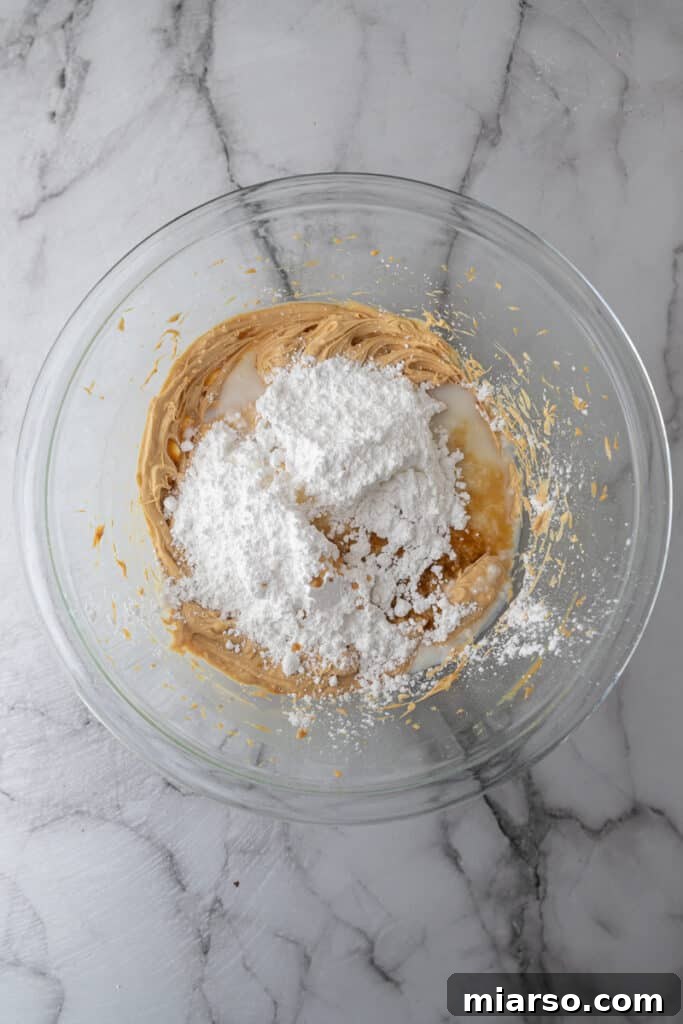 powdered sugar over other ingredients in a bowl