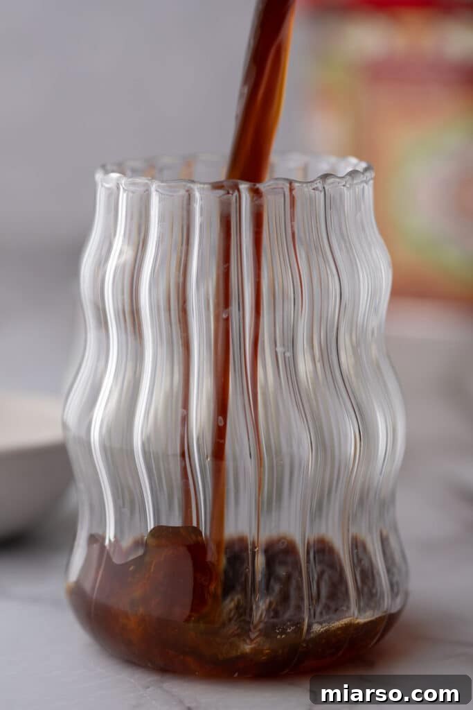 coffee being poured into a glass