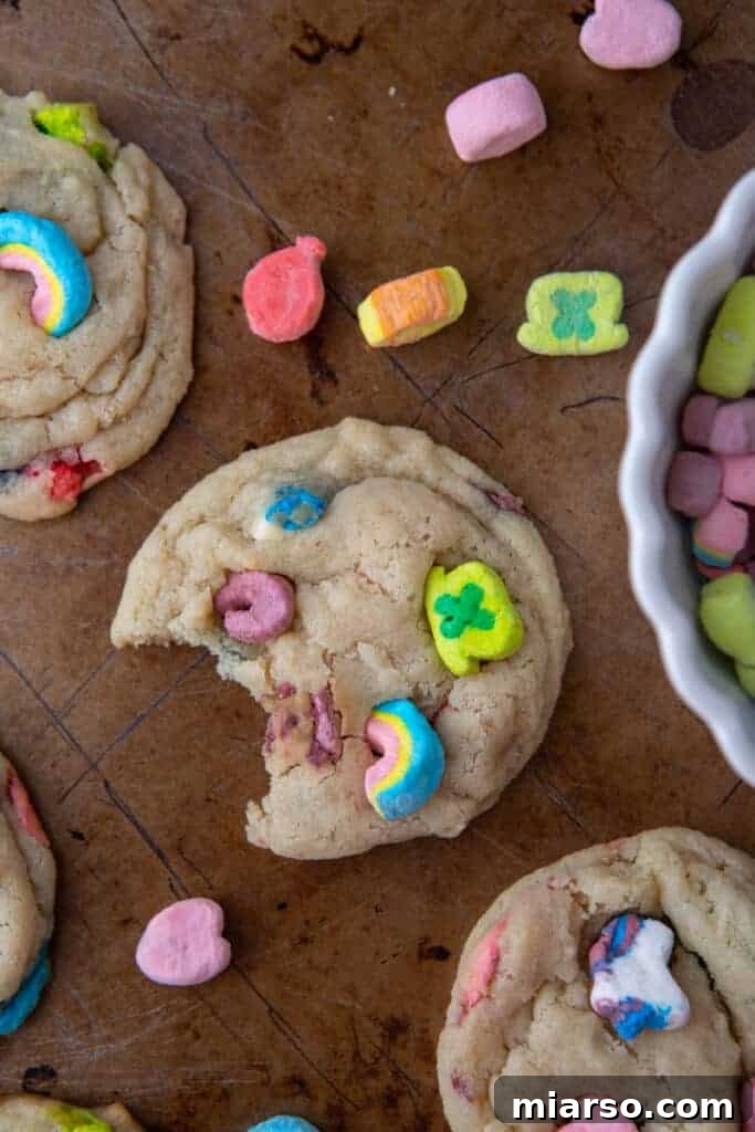 Magical Lucky Charms Cookie Delights 8 Baked Lucky Charms cookies on a baking sheet, cooling down