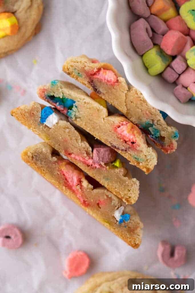 Magical Lucky Charms Cookie Delights 9 Halved Lucky Charms cookies stacked, showing the fluffy interior and colorful marshmallows