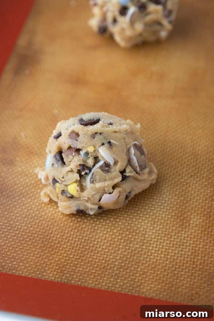 ball of raw cookie dough on a baking sheet