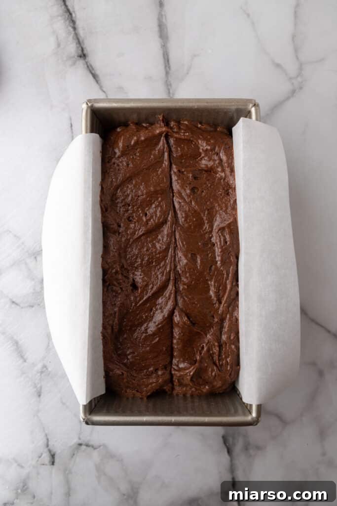 Ultimate Decadent Chocolate Pound Cake Recipe 7 Raw chocolate pound cake batter smoothed into a loaf pan, ready for the oven.
