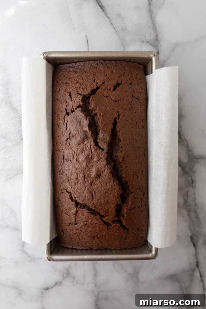 Ultimate Decadent Chocolate Pound Cake Recipe 8 A fully baked chocolate loaf cake cooling in its pan, just out of the oven.