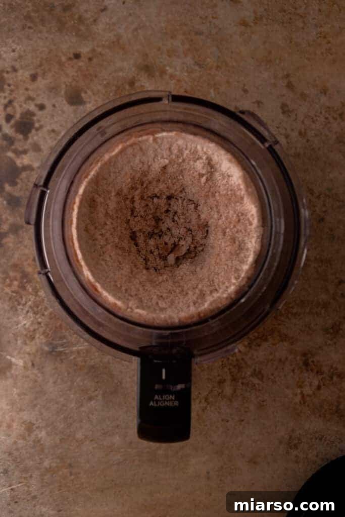 Elevate Your Protein Ninja Creami Ice Cream Perfection 4 Partially mixed protein shake and pudding mix in a Ninja Creami pint