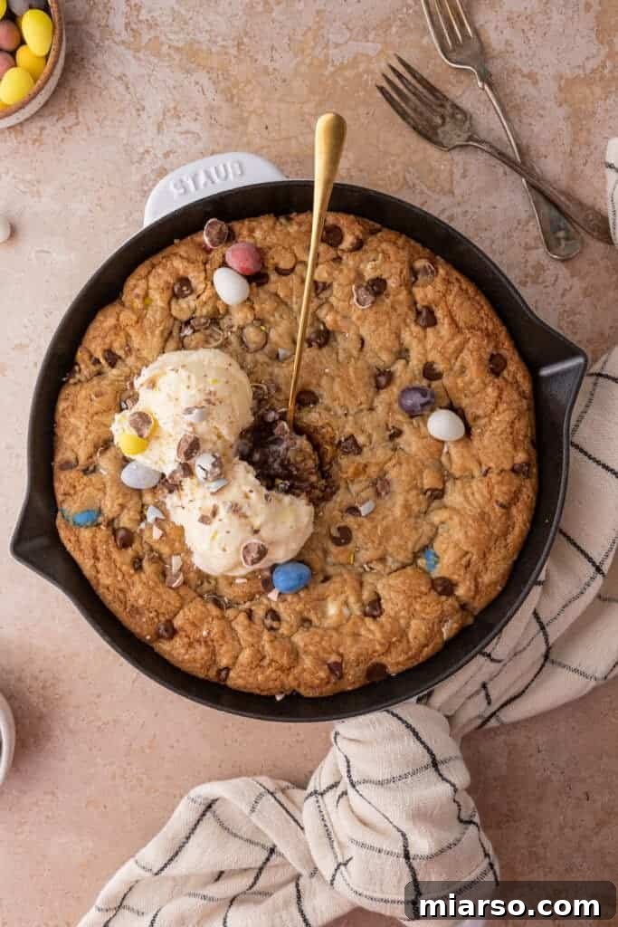 Gooey Giant Cadbury Mini Egg Skillet Cookie 2 A perfectly baked Cadbury Mini Egg Skillet Cookie, golden brown and studded with colorful mini eggs.
