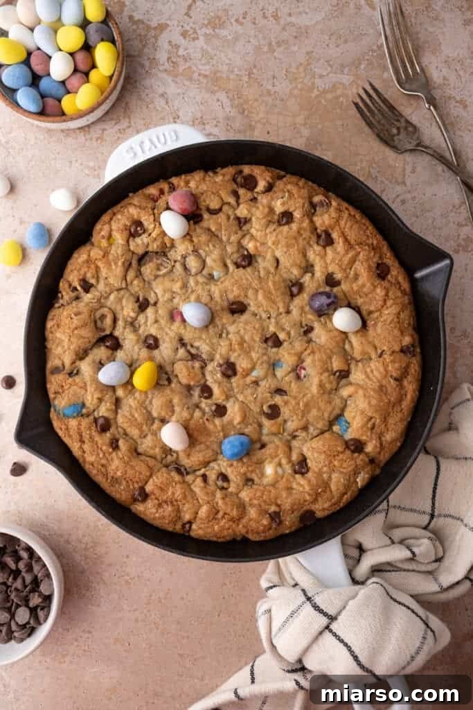 Gooey Giant Cadbury Mini Egg Skillet Cookie 12 Top-down view of a Cadbury Mini Egg Skillet Cookie, showcasing its vibrant colors and inviting texture.