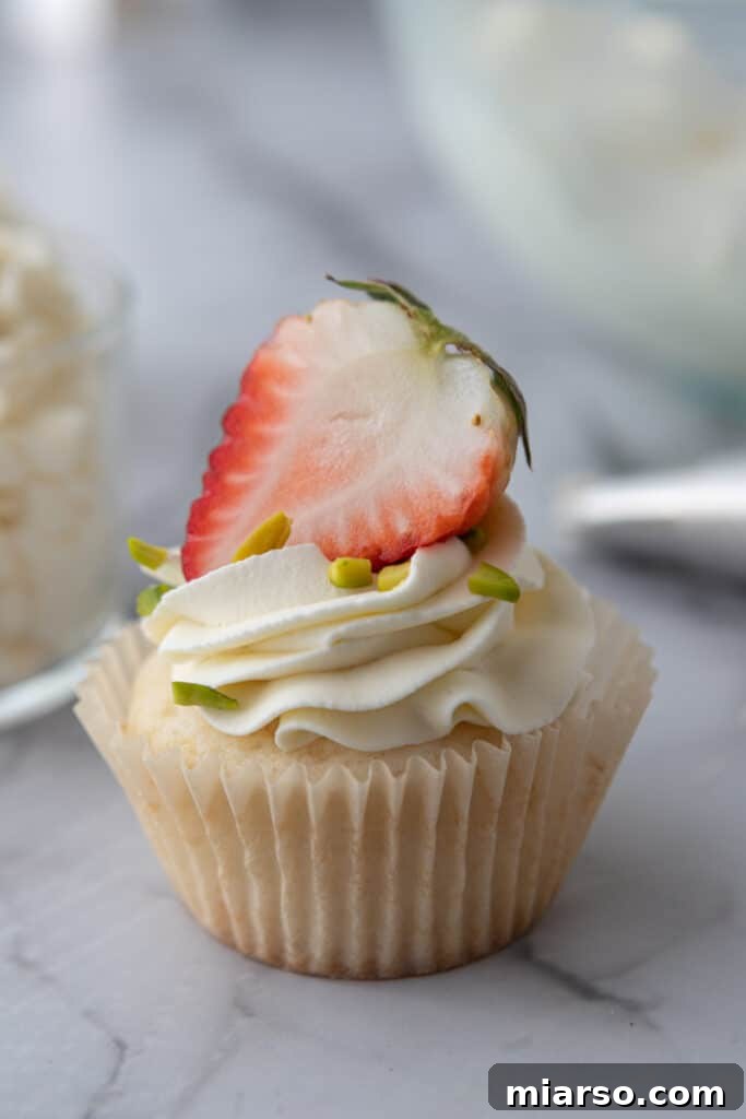 Mascarpone Frosting Perfection 4 mascarpone cake frosting recipe on a cupcake with a strawberry on top