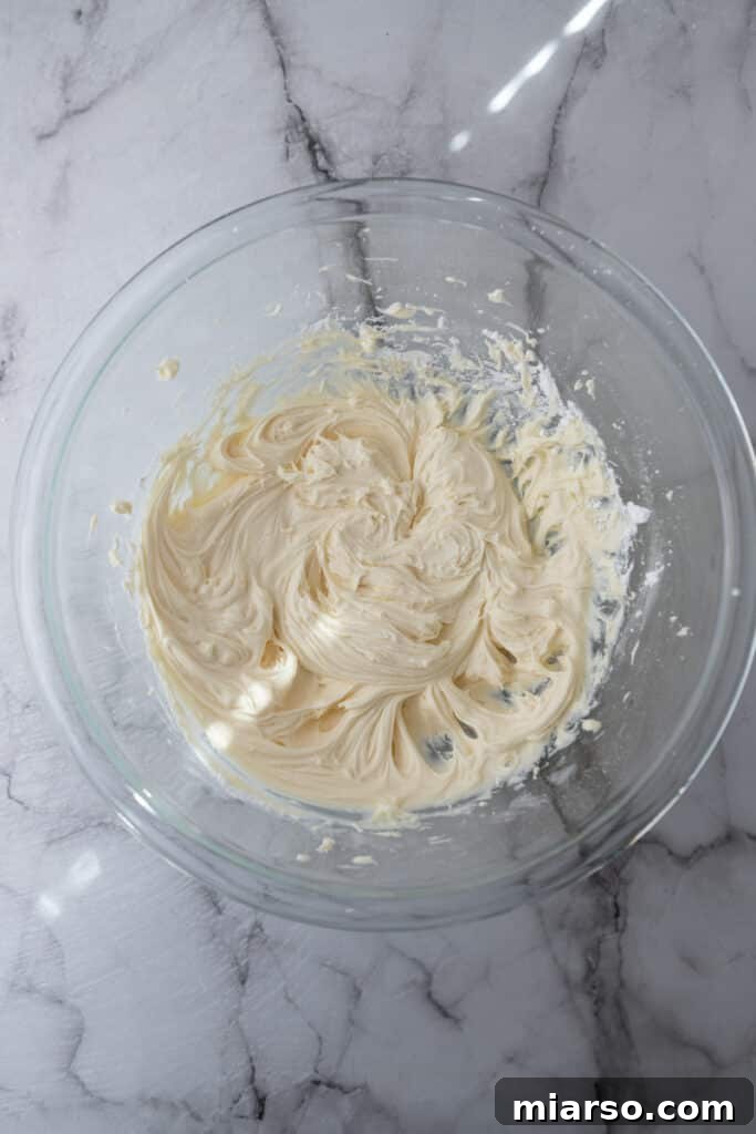 Mascarpone Frosting Perfection 6 partially mixed ingredients in a bowl