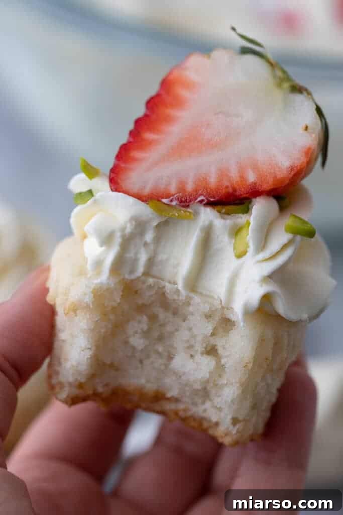 Mascarpone Frosting Perfection 8 a cupcake with icing and a strawberry on top