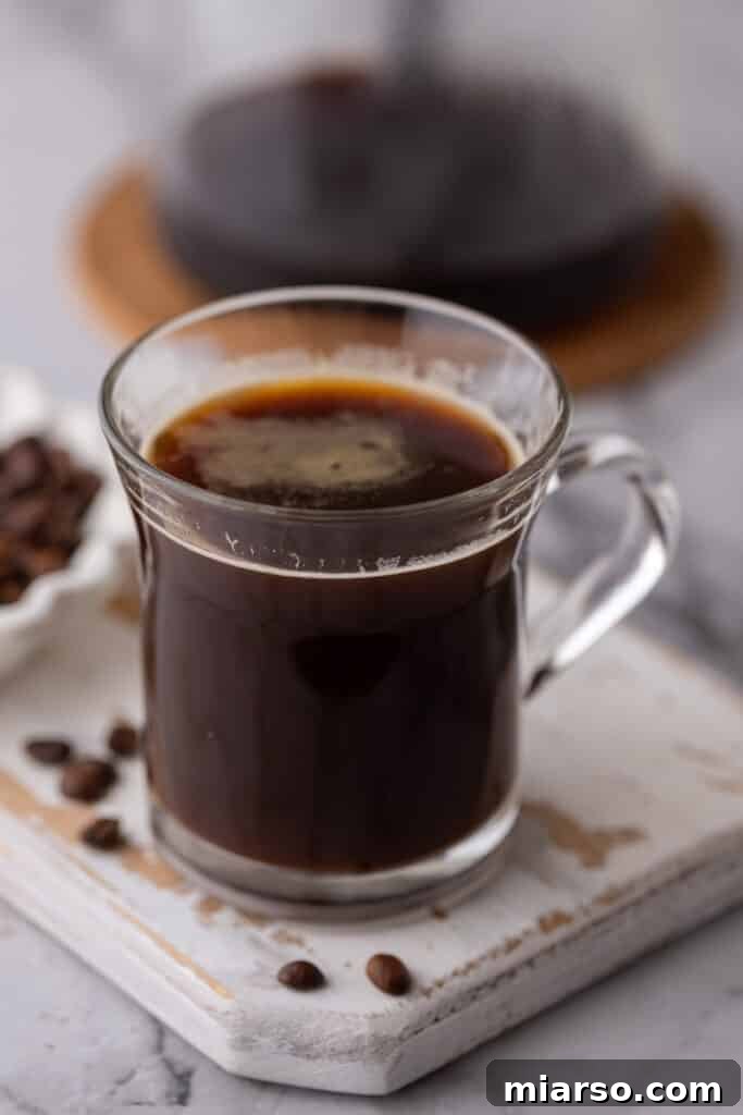 Red Eye Coffee Recipe in a glass on a coaster, a perfect energizing drink