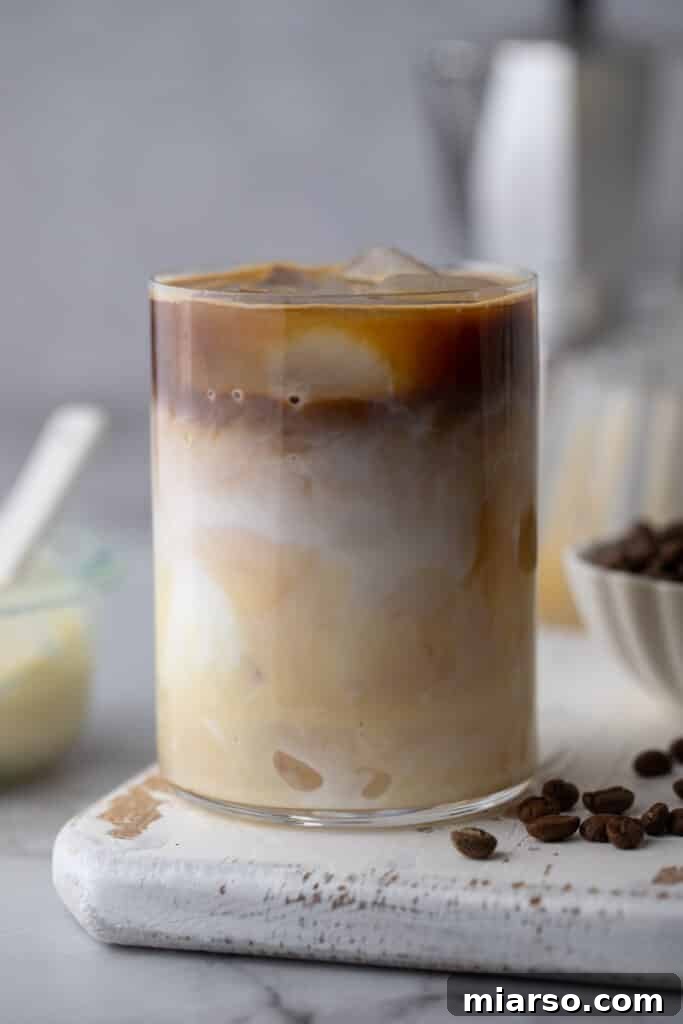 Decadent Homemade Spanish Latte Recipe 6 espresso, milk and sweetened condensed milk in a glass with ice