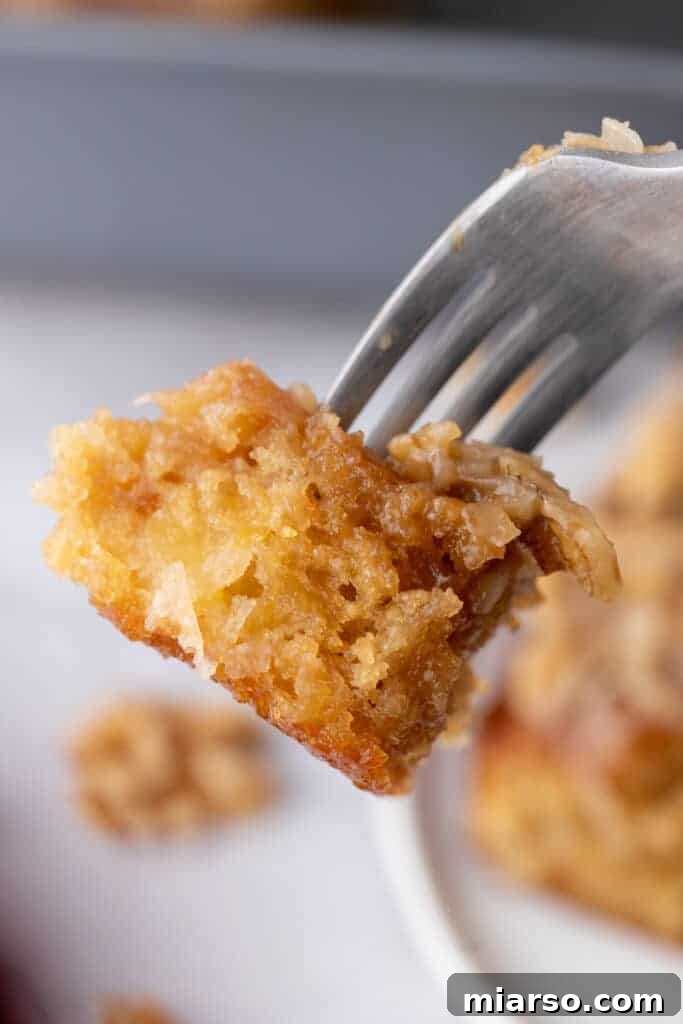 A delicious piece of Tornado Cake recipe, perfectly moist and fluffy, held on a fork.