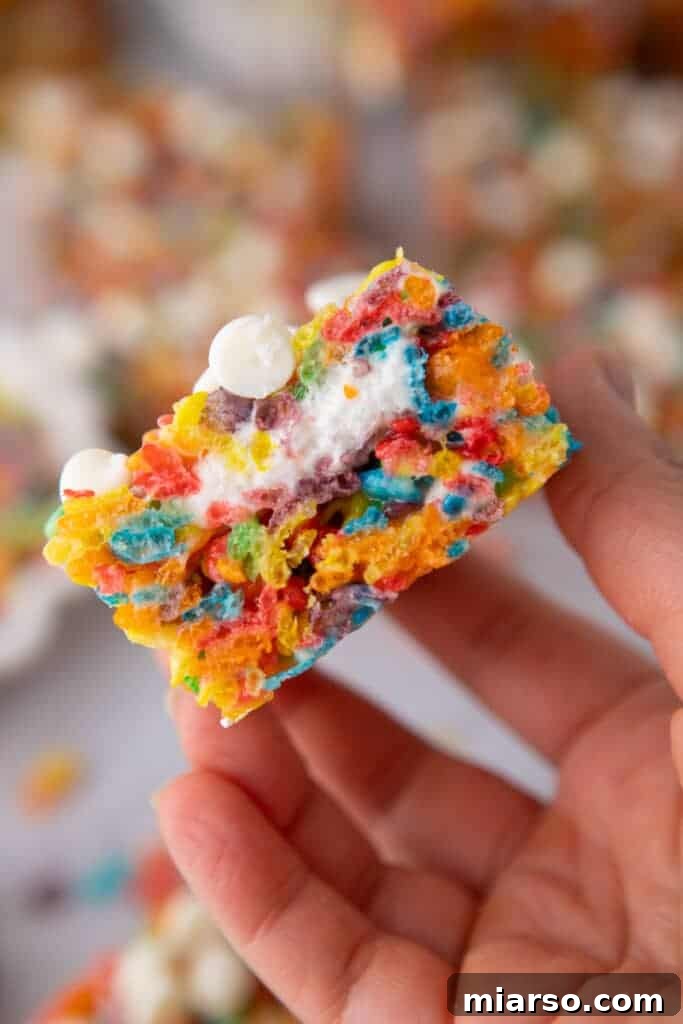Quick Colorful Fruity Pebble Krispie Treats 9 Hand holding Fruity Pebbles Rice Krispies