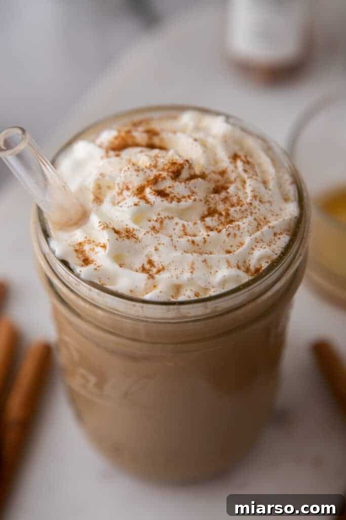 Angled overhead shot of a maple latte, showing the glass cup and the warm, inviting colors of the drink.
