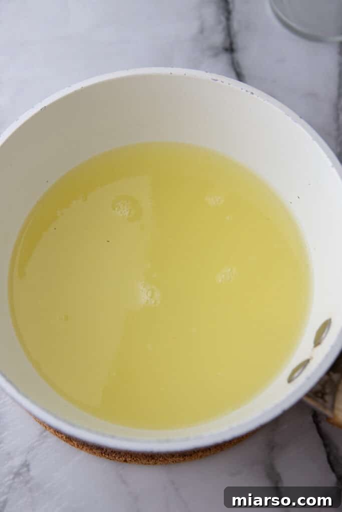 Lemon and lime juice added to the simple syrup in a pot