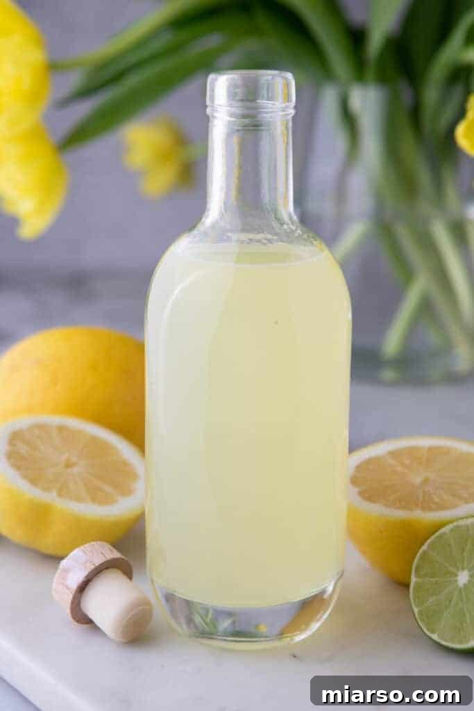 Elegant side shot of the clear lemon sour mix liquid in a bottle