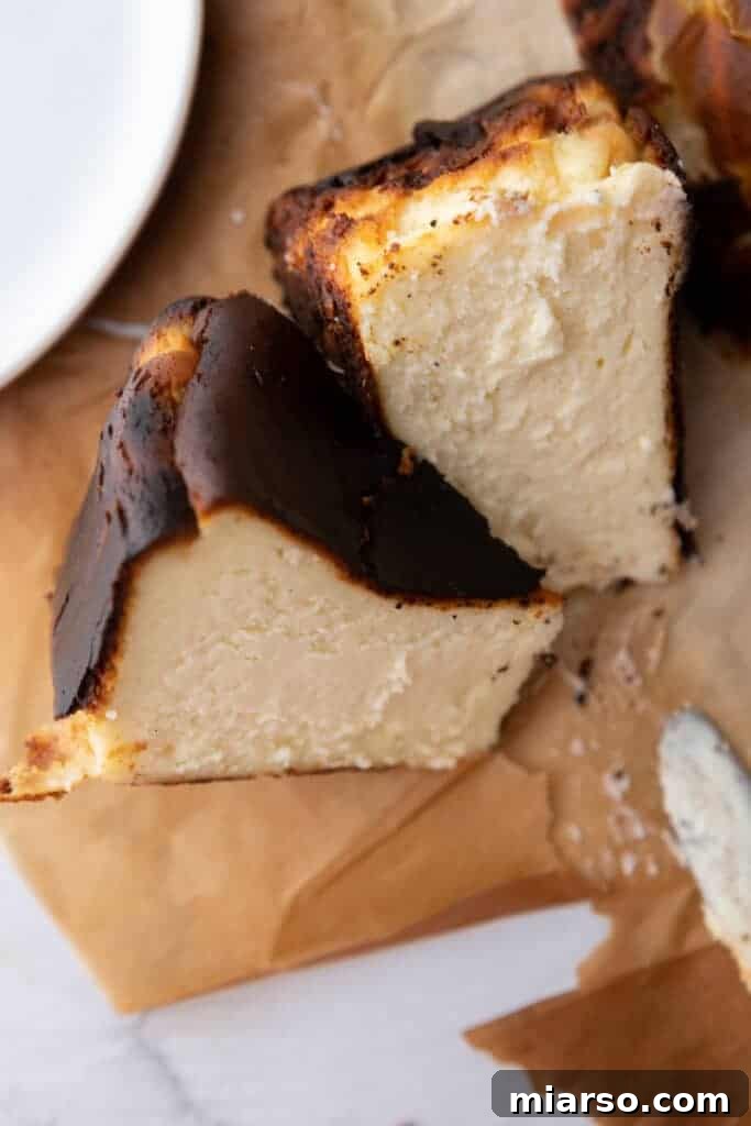 Slices of 6-inch Burnt Basque Cheesecake on parchment paper, showcasing the dark top and creamy interior