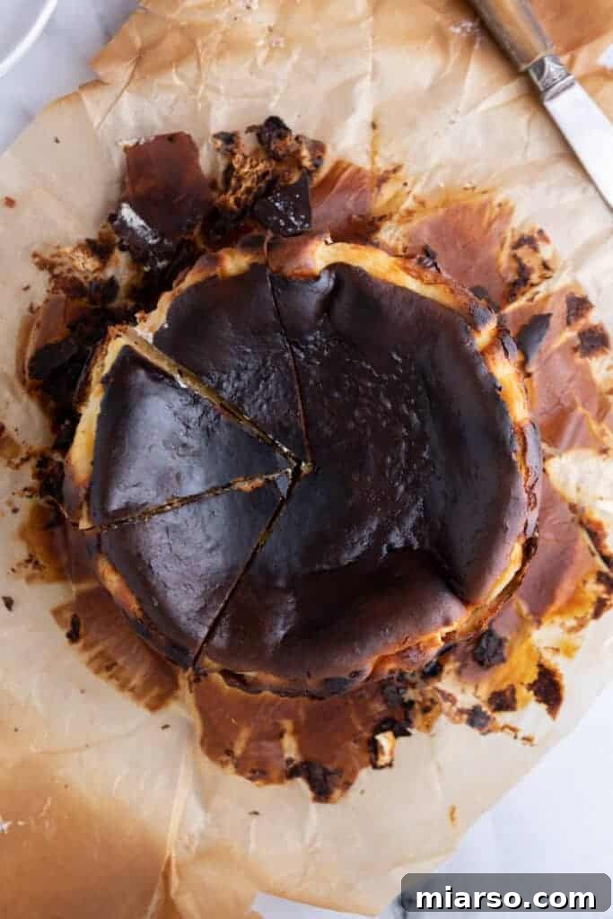 Overhead view of a sliced Burnt Basque Cheesecake, revealing its rich texture
