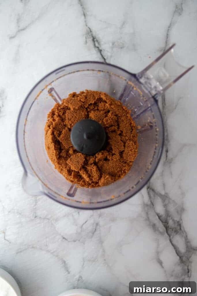Unmixed Biscoff cookie crust ingredients in a bowl, ready to be combined.