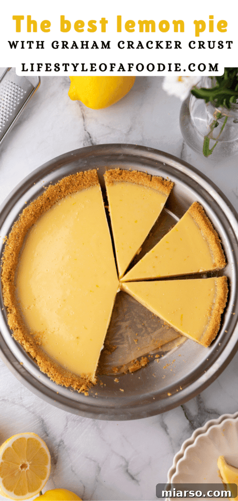 Pinterest pin showing a close-up slice of lemon pie with graham cracker crust and whipped cream, highlighting its creamy texture