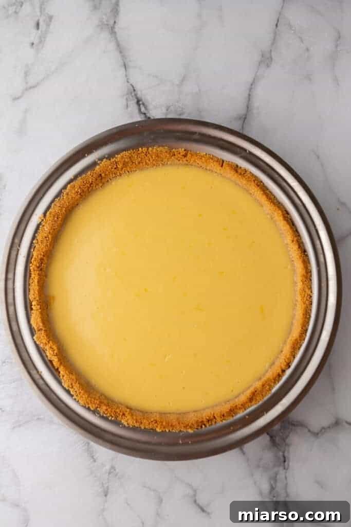 A fully baked lemon pie, with a set golden filling and crust, just out of the oven in its pan