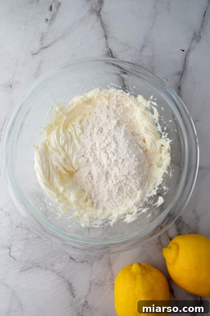 Unmixed crust ingredients in a bowl: butter, powdered sugar, flour, and salt.
